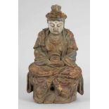 BuddhaChina, 19. Jahrhundert. Holz. Reste von polychromer Bemalung. H. 35,5 cm. Sitzend mit