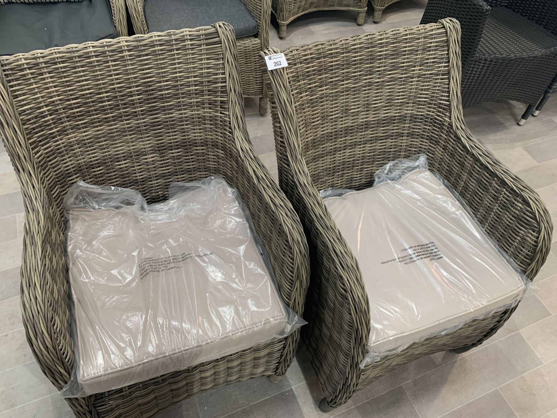 A Pair of woven Maze Rattan arm chairs with cushion seats