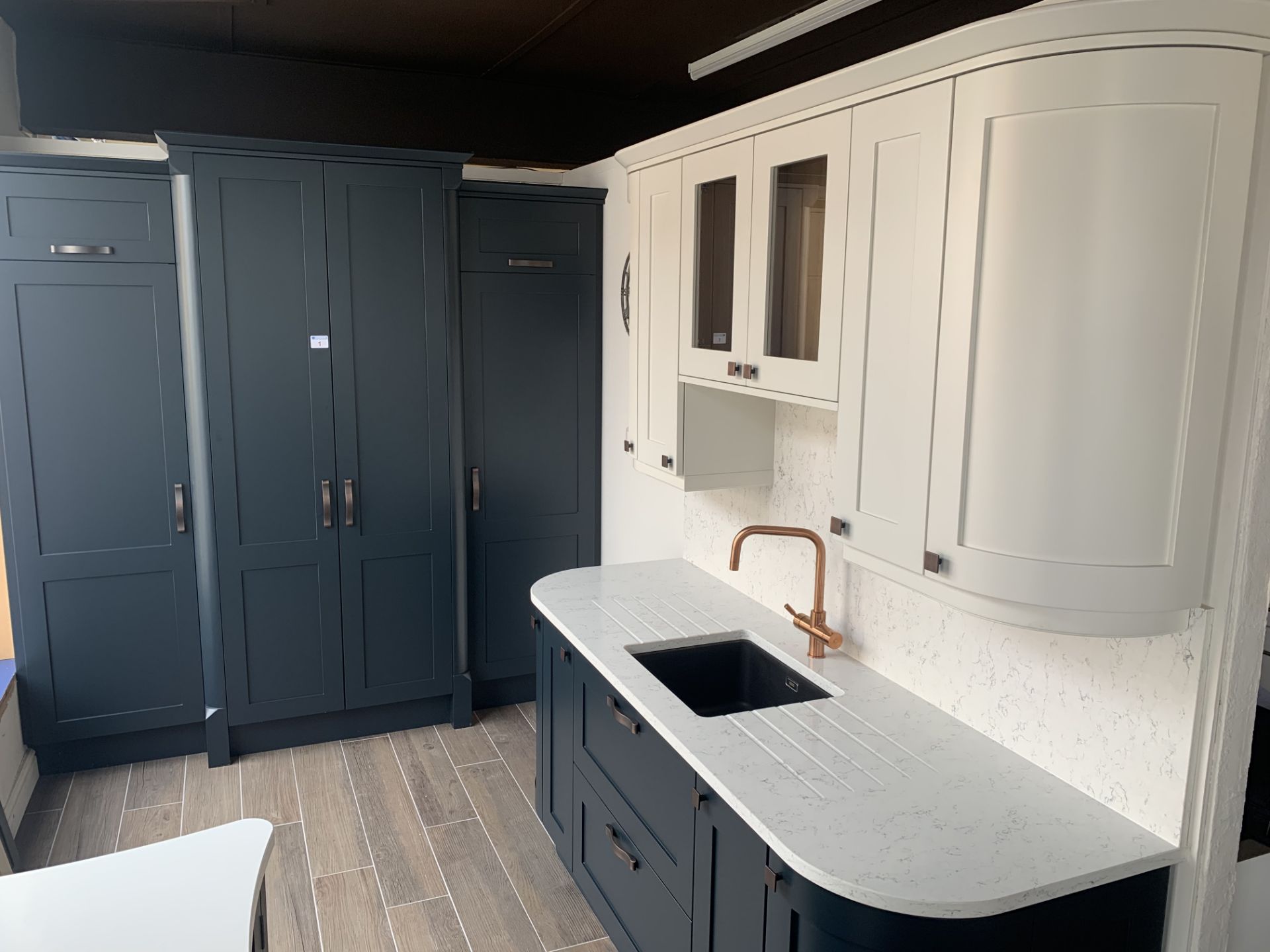 Shaker kitchen pantry with fridge and freezer, sink cabinets below and above with boiler tap