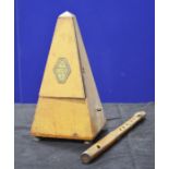 A wooden piccolo and a wooden cased metronome. (2