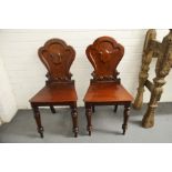 A pair of 19th century mahogany armorial hall chai