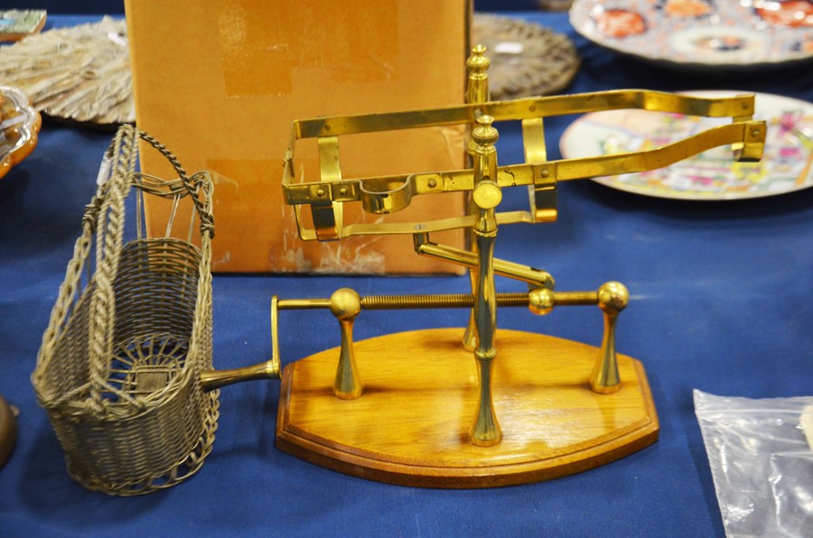 A brass racheted wine bottle decanter on wooden ba