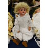 An Armand Marseille doll, with porcelain head, bl