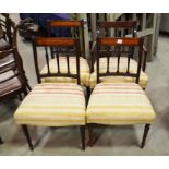 A set of four upholstered dining chairs with balus