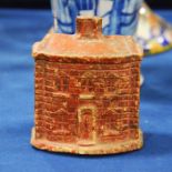 A Staffordshire cottage money box, 19th century, painted red with slot to the roof, 10.5cm high