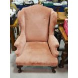 A Victorian upholstered wing back armchair, in the