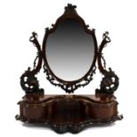 A Victorian carved mahogany swing toilet mirror