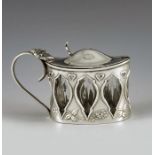 Henry Wilkinson, Birmingham 1909, an Arts and Crafts silver mustard pot, pierced oval cylinder form,