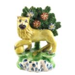A Staffordshire pottery bocage pearlware figure of a lion