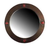 An Arts and Crafts copper and cabochon set mirror