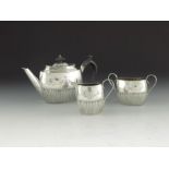 A Victorian silver bachelors three piece tea set, William Hutton and Sons