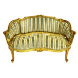 A Louis XV style carved giltwood settee