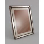 An Arts and Crafts silver and rosewood photo frame