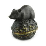 A Japanese bronze figure of a rat on a walnut