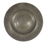 A 17th century pewter broad rimmed alms dish