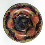 William Moorcroft, a Pomegranate on ochre bowl, circa 1925, low tazza form, impressed and painted ma