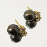 A pair of black pearl and white stone stud earrings