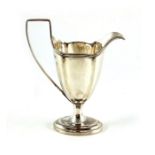 An Edwardian silver pedestal jug, Thomas Bradbury and Sons