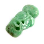 A Chinese carved green jadeite pendant