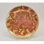 A lustre plate, painted with a lion within foliate scroll ground