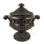 A Victorian cast iron urn and cover