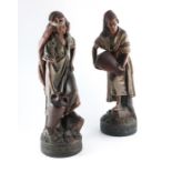 A pair of large Continental terracotta figures of water carriers