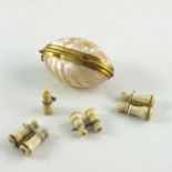 A yellow metal mounted mollusc shell case, containing four miniature bone Stanhopes