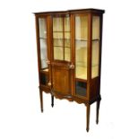 A Edwardian mahogany and satin wood inlaid display cabinet, the central concave glazed panel above a