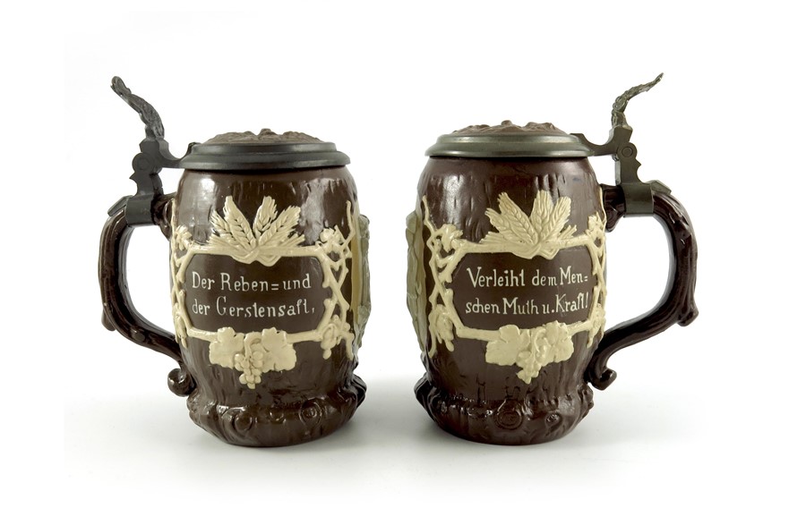 Mettlach, Villeroy and Boch, a pair of half litre steins, relief moulded and applied tree stump and