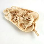 λ A 19th century carved ivory scholars wrist rest / okimono