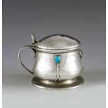 Archibald Knox for Liberty and Co., Birmingham 1912, an Arts and Crafts silver and turquoise set mus