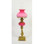 A Victorian cast brass and opaque glass oil lamp
