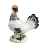 A Meissen figure of a hen laying an egg