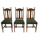 Shapland and Petter (attributed), six Arts and Crafts oak dining chairs