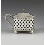 S W Smith and Co., London 1913, a George V silver mustard pot, straight sided ovoid form, reticualte