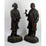 A pair of Austrian terracota figures of peasant boys
