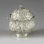 Kashmir, circa 1890, a Persian white metal mustard pot, lotus flower form, heavily engraved in relie