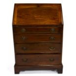 An Edwardian mahogany fall front bureau of small proportions