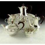 A E Jones, an Arts and Crafts silver six piece tea and coffee set, Birmingham 1927 to 1935