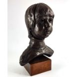 A bronzed plaster bust of a boy