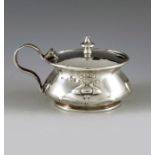 Samuel Levi, Birmingham 1901, an Arts and Crafts silver mustard pot, squat baluster form embossed wi