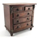 An early Victorian mahogany miniature chest of two short over three long drawers