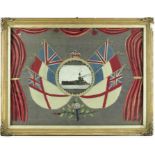 A World War One woolwork picture with central postcard of HMS Iron Duke