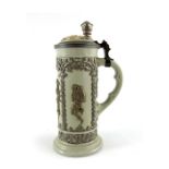Mettlach, Villeroy and Boch, a half litre stein, relief moulded drinking figures in lustre foliate a