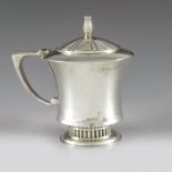 R E Stone, London 1960, a Modernist silver mustard pot and spoon, planished, footed and waisted trum