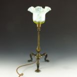 An Arts and Crafts brass Pullman type table lamp with straw opal glass shade