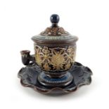 A Doulton Lambeth Isobath inkwell, relief moulded with foliate cartouche design, with cover and undu