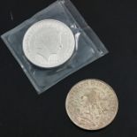 A Britannia silver bullion coin and a Mexico 25 pesos Olympics coin