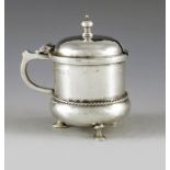 A E Jones, Birmingham 1919, an Arts and Crafts silver mustard pot, planished, cylindrical bulbous fo