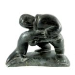 An Inuit carved stone sculpture, signed D Erkot